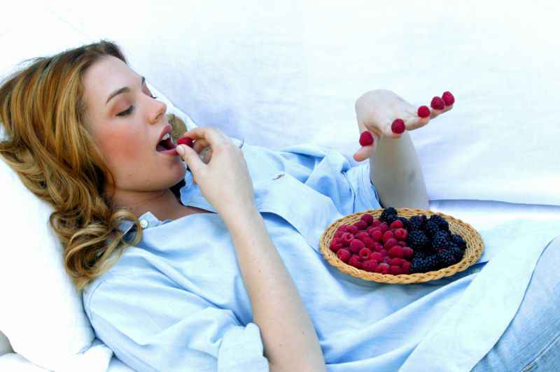 young woman eating berries